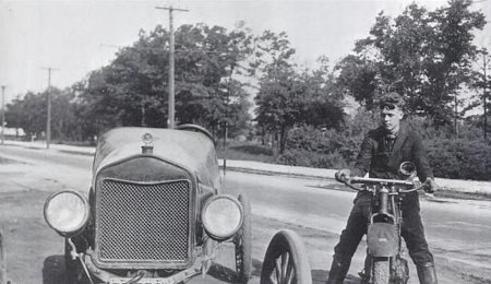 young charles lindbergh on motorcycle next to car