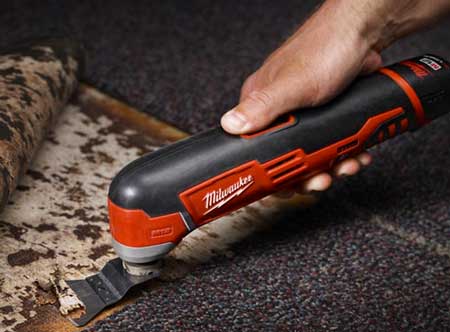 milwaukee oscillating multi-tool in use cutting flooring 