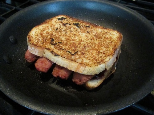 Then the hot dog slices. The four pieces perfectly cover the piece of bread. Then slap on the jellied piece of bread. Cook just like you would a grilled cheese. It's a little tricky to flip, so be prepared.