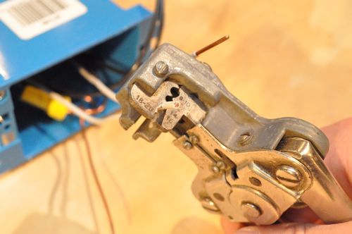 Line up the white (neutral) wires and cut them to an equal length. Next, strip back the insulation with wire strippers.