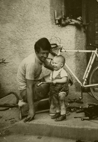 vintage cyclist father with bike and baby