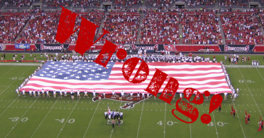 Giant American flag on a football field.