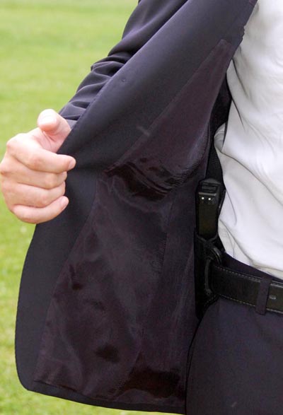 concealed carry style blazer handgun showing jacket open 