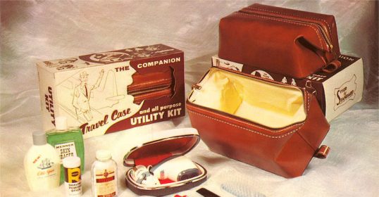 A brown leather Dopp Kit with a toothbrush, toothpaste, and other items.