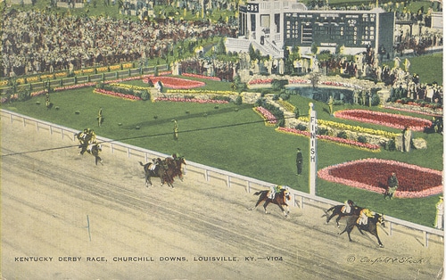 A picture of a horse race at the Kentucky Derby with people dressing up and watching.