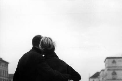 A black and white photo capturing a couple strolling through a city, offering a DIY perspective on marital bliss.