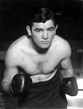 Description: A black and white photo of James J. Braddock, a man in boxing gloves.