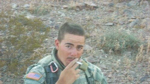 An Army Scout smoking a cigarette in the desert.