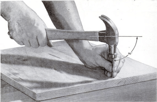 A person wielding a hammer skillfully on a piece of wood, showcasing excellent toolmanship.