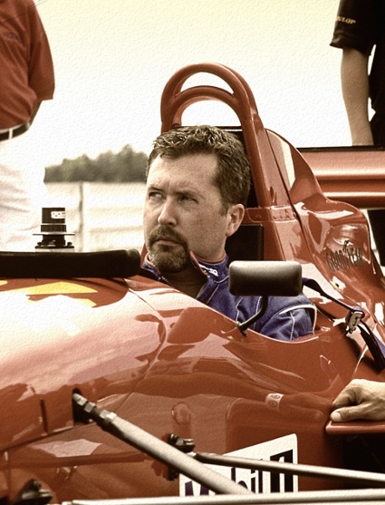 An SEO expert sitting in a red racing car.