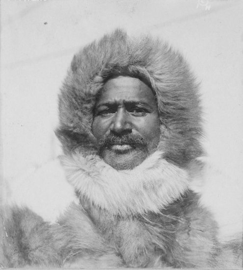 A vintage photograph capturing the manliness of Matthew Henson in a luxurious fur coat.