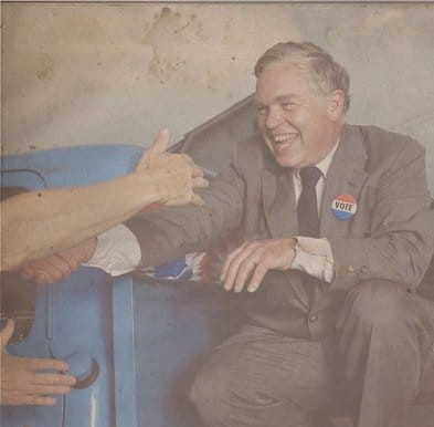 A man is shaking hands with a man in a suit during a local office political campaign.