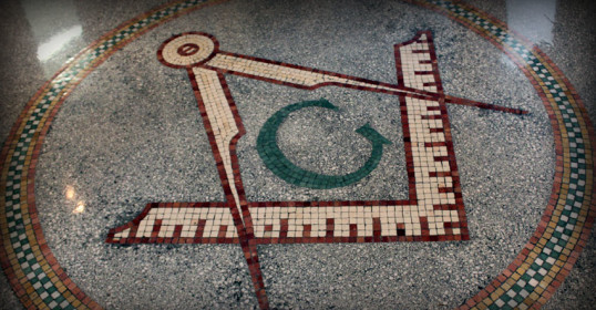 An image of a masonic symbol on a tile floor showcasing the Freemasonry tradition.