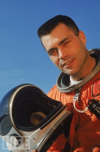 Nick Piantanida, a man with a passion for skydiving and space exploration, wearing an orange space suit, grips his helmet tightly.