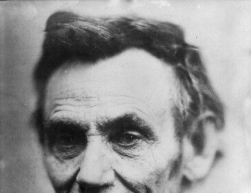 A portrait of Abraham Lincoln, bathed in soft and gentle light, illuminating his dignified expression.