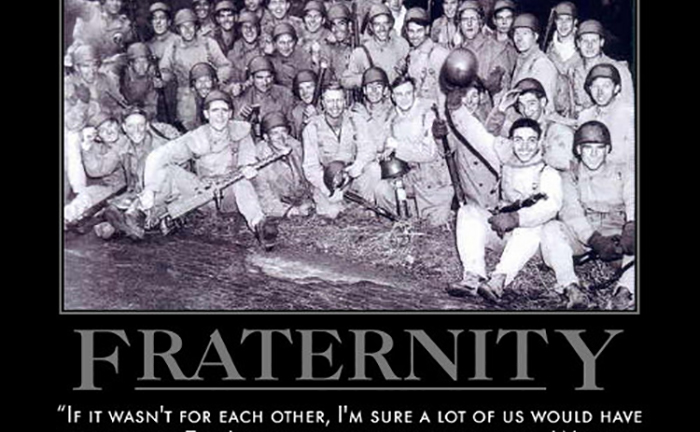 A group of people are posing for a photo with the words "band of brothers.