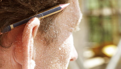 A man with a pencil in his ear displaying practical wisdom.