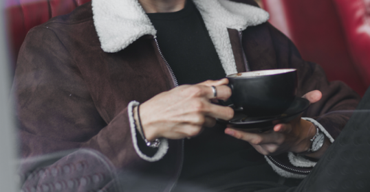 A woman holding a cup of coffee.