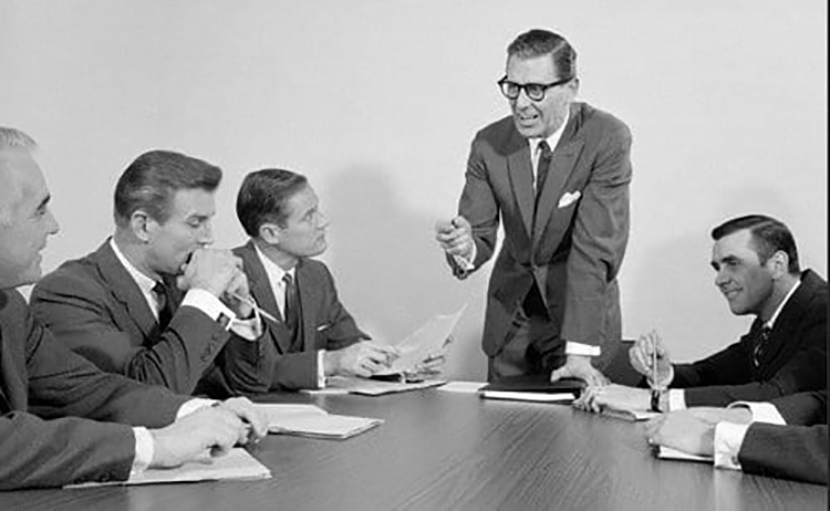 A SEO expert and a well-spoken manager are seated at the conference table.