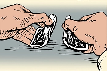 Two hands skillfully tearing a deck of cards with a pattern on it.
