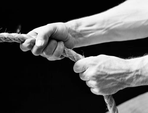 A forgetful man captured in a striking black and white photograph, tightly holding fast to a rope.