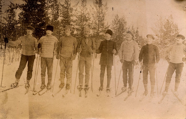 A group of skiers wearing Men's Winter Hats posing for a picture.