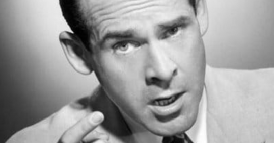 A black and white photo of an assertive man pointing his finger.