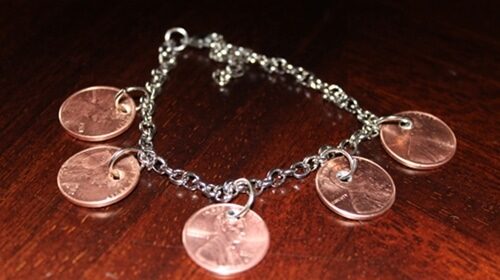 A DIY Penny Charm Bracelet with four coins on it.