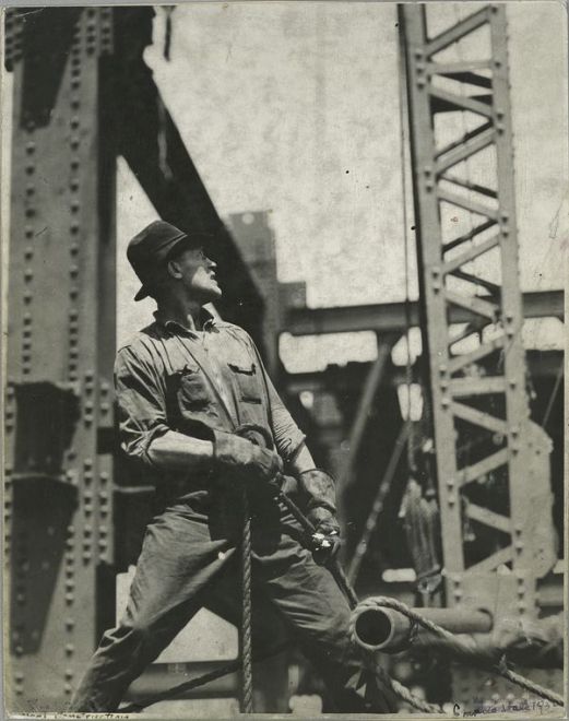 A man exhibiting strength and majesty as he stands on an old bridge.