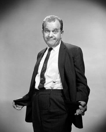 A black and white photo of a man in a suit, showcasing elegance and sophistication.