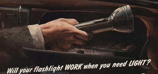 An old advertisement for a flashlight features a man carrying the latest in flashlights.