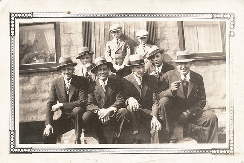 A manly group posing for a photo.