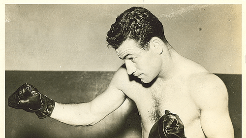 A man wearing boxing gloves throwing punches.