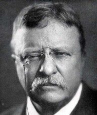 An old photo of Theodore Roosevelt, a man with glasses and a mustache.