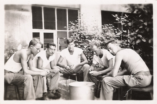 A group of men gathering to review and discuss manhood while sitting around a pot.
