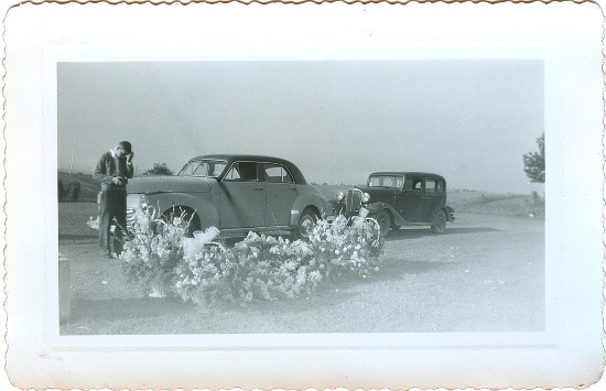 A grief-stricken friend seeks help alongside an old photo of two men standing next to a car.