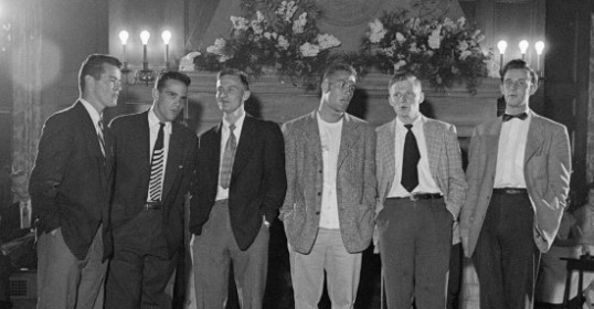 A group of men in blazers standing next to each other.