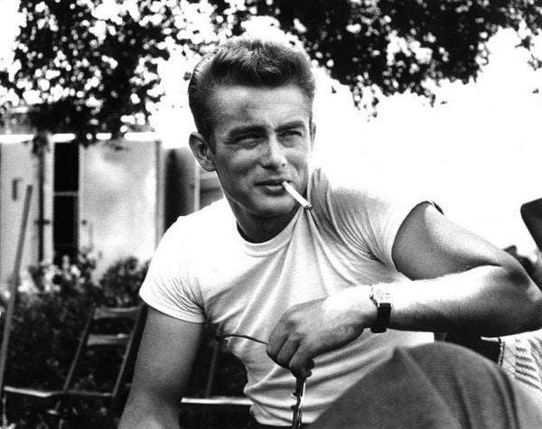 A black and white photo of a man smoking a cigarette.