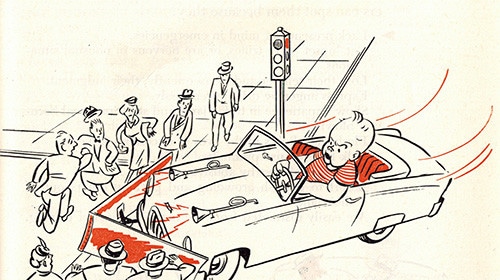 A vintage car drives through a crowd of people.