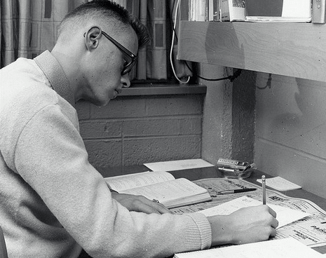 A young man sitting at an important desk.