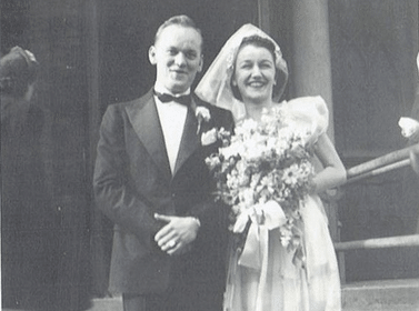 A black and white photo of a groom and bride.