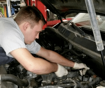An automotive technician repairing a car engine.