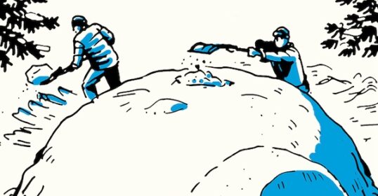 Two people shoveling snow outdoors to build a Quinzee Snow Shelter.