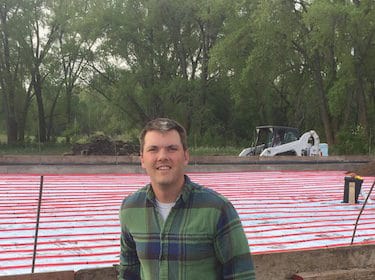 A mason standing next to a concrete slab.