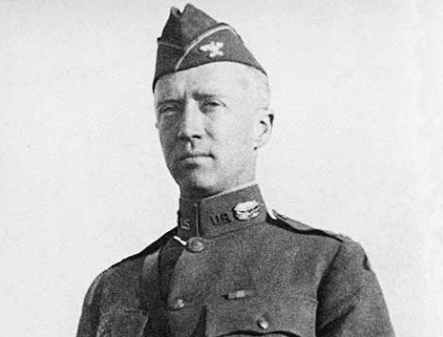 A black and white photo of an officer in uniform.