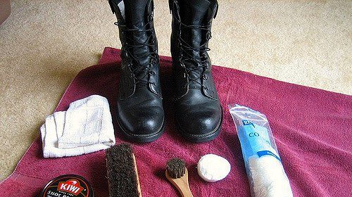 The ultimate guide to shining black leather shoes and other items on a towel.