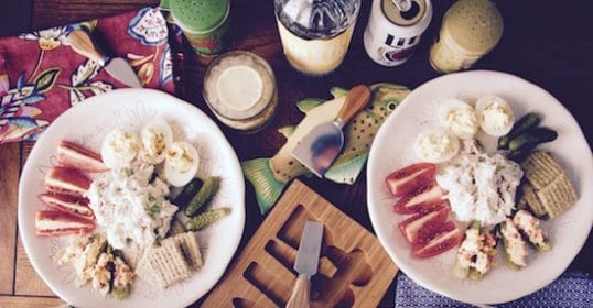 Two plates of food on a wooden table perfect for a cold supper.