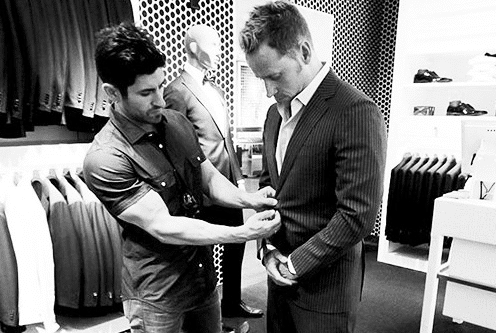 A man is upgrading a suit in a store.