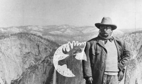A man standing on top of a mountain with the words 