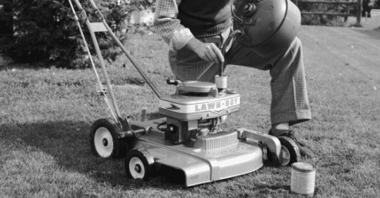 A man is maintaining his lawn with a mower.